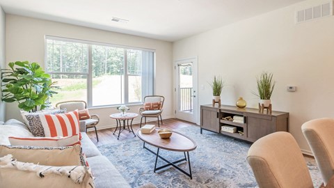 a living room with furniture and a large window